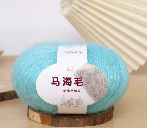 Single ball of mohair yarn in various colours for hand-woven DIY scarf knitting projects