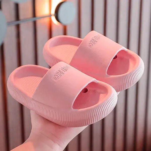 Children's non-slip EVA slippers in bright colours, showing the 1.5cm thick sole.