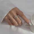 Gold and silver leaf-shaped branch ring for women on a white background.