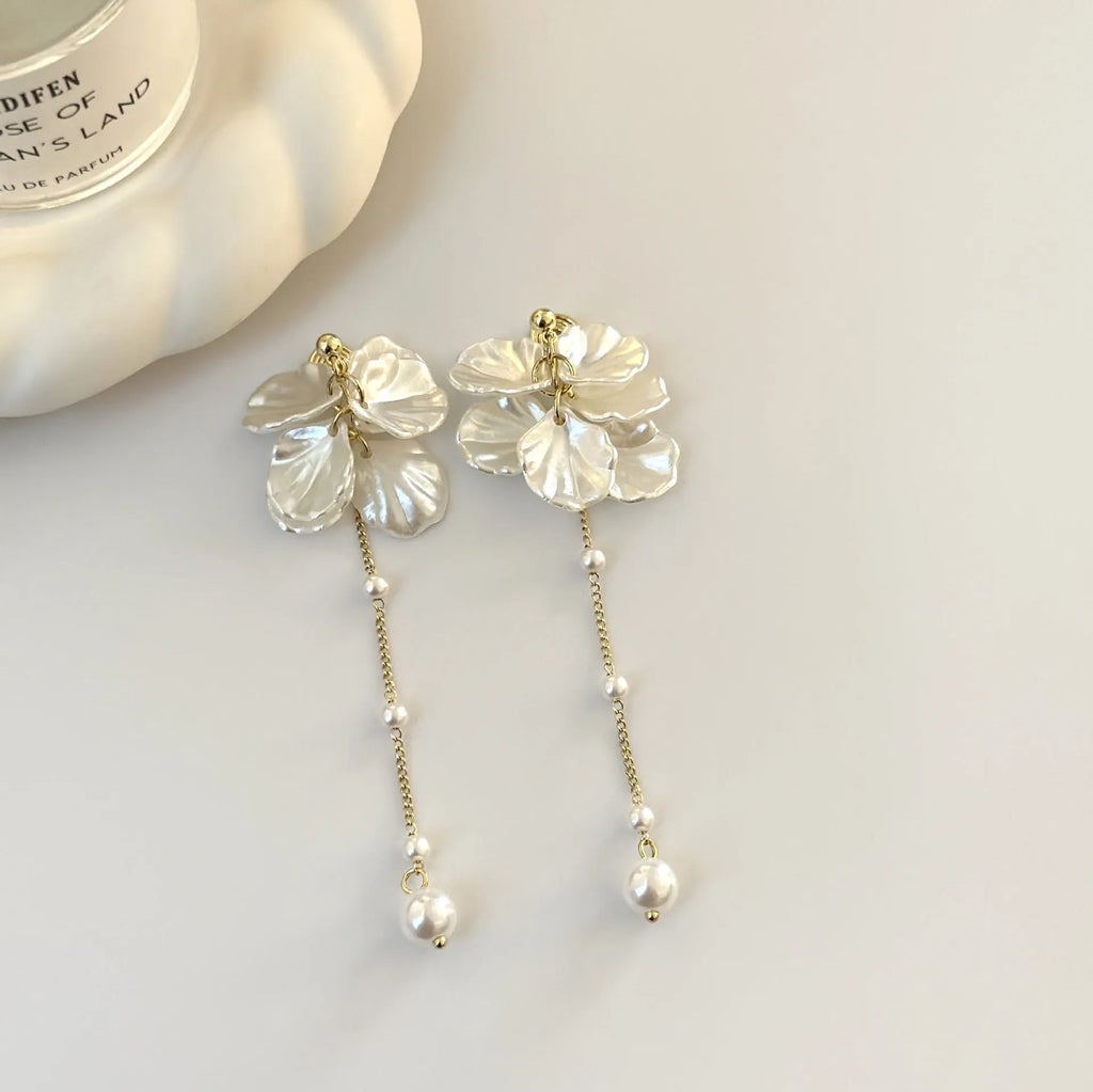 Women's acrylic shell pearl tassel earrings showing four different clip style options