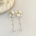 Women's acrylic shell pearl tassel earrings showing four different clip style options
