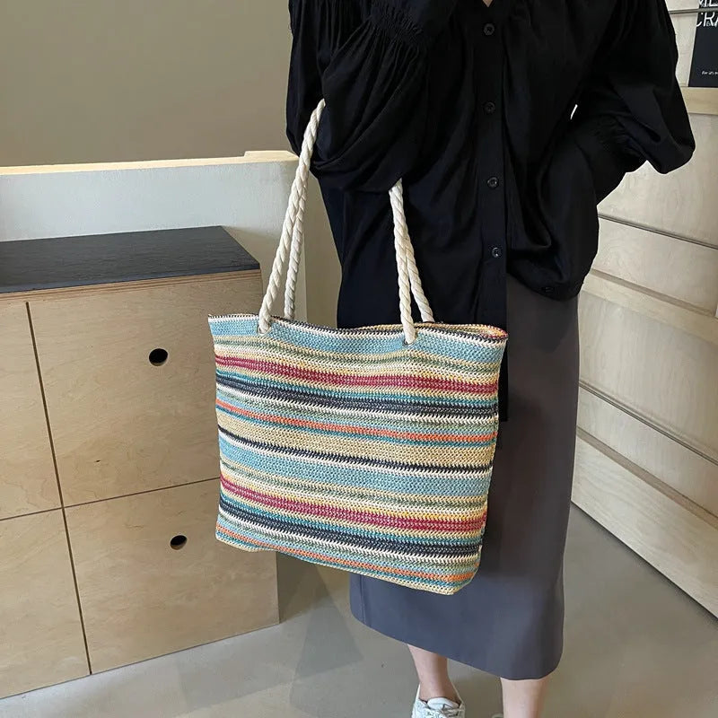 Blue straw woven large capacity nylon shoulder bag with a single strap.