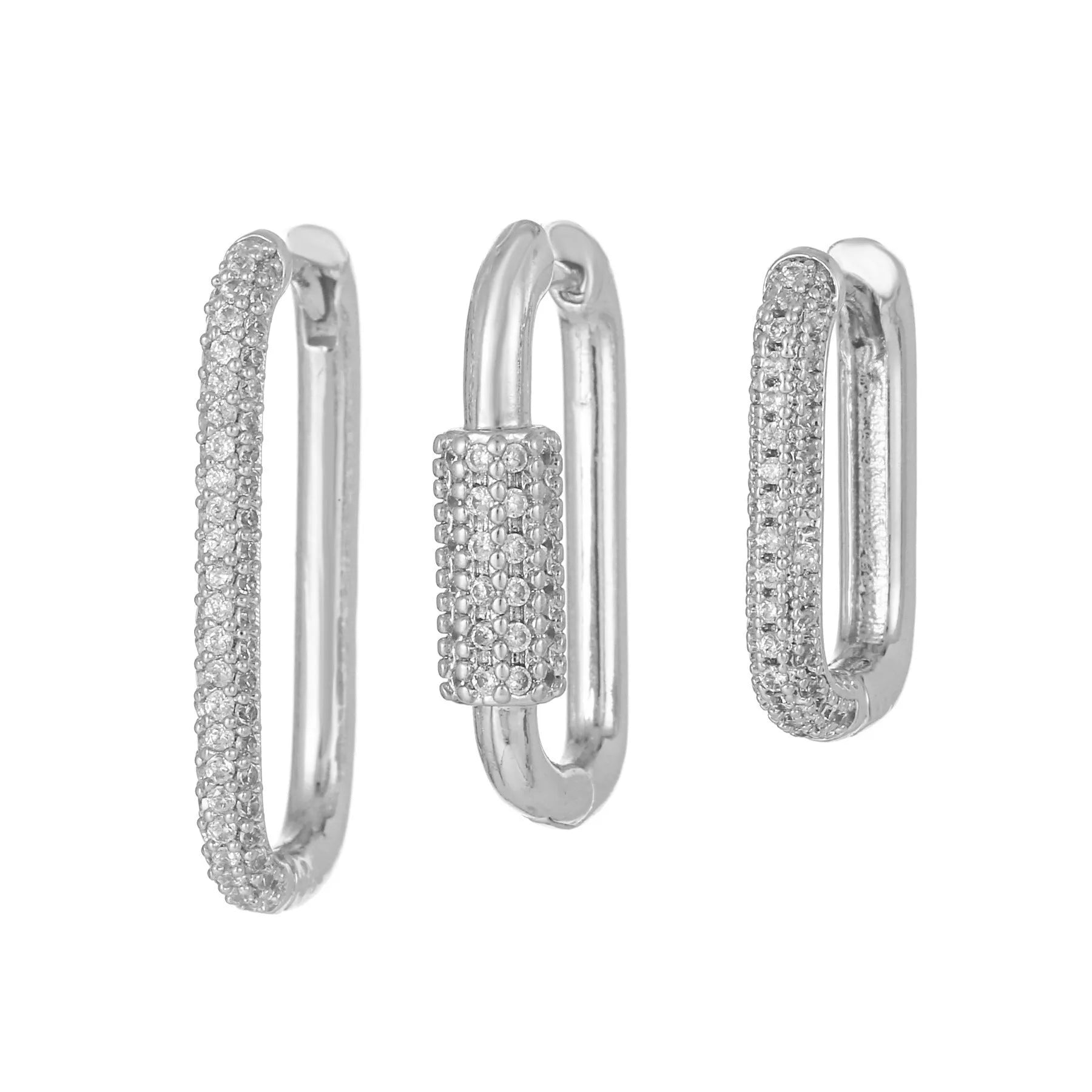 Three geometric square ear clips with inlaid zircon details in gold and white finishes on a grey background.