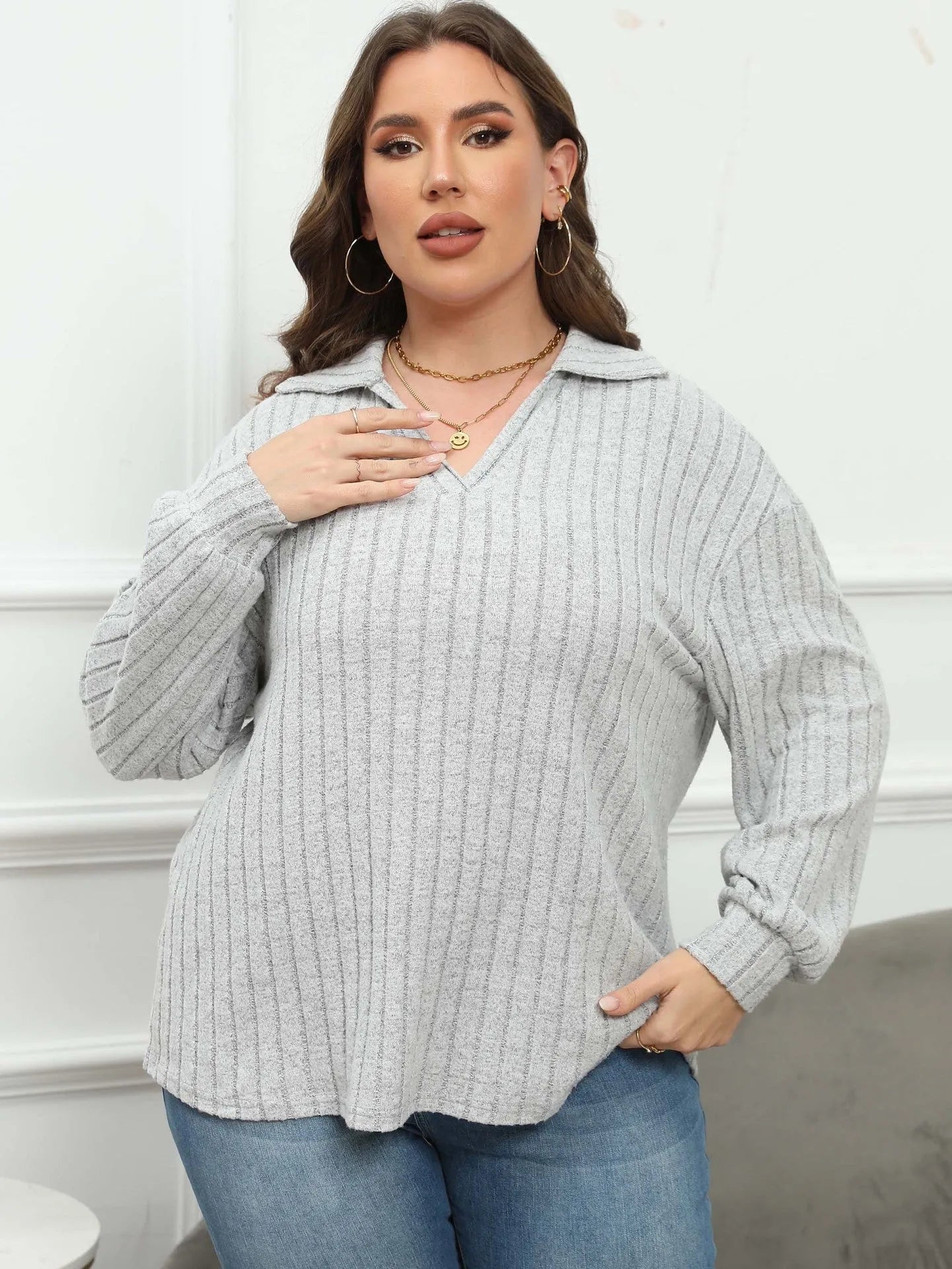 Women's plus size gray polo collar fleece shirt with lantern sleeves on a hanger