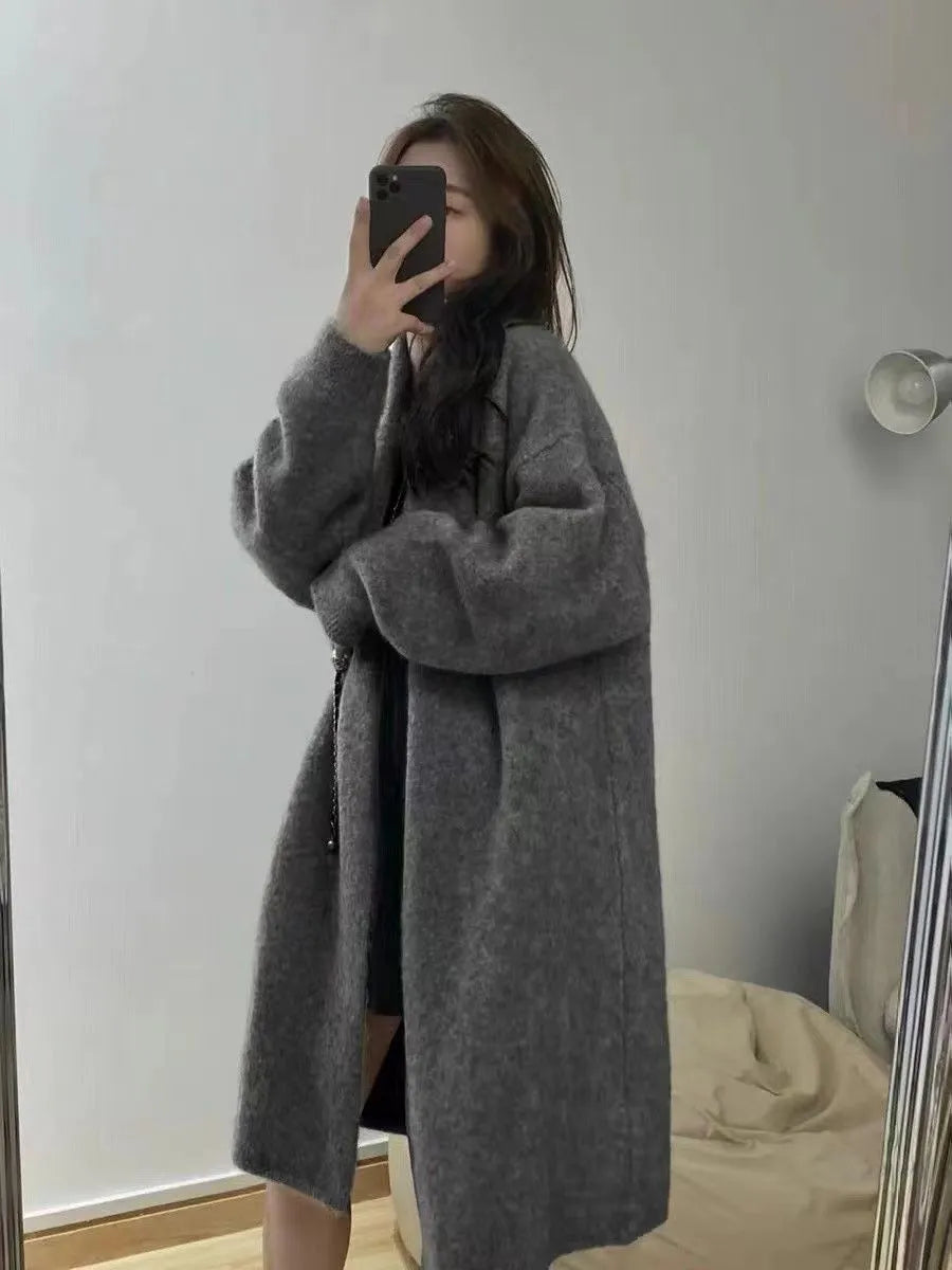 Women's knitted V-neck cardigan in loose fit showing mid-length silhouette and long sleeves