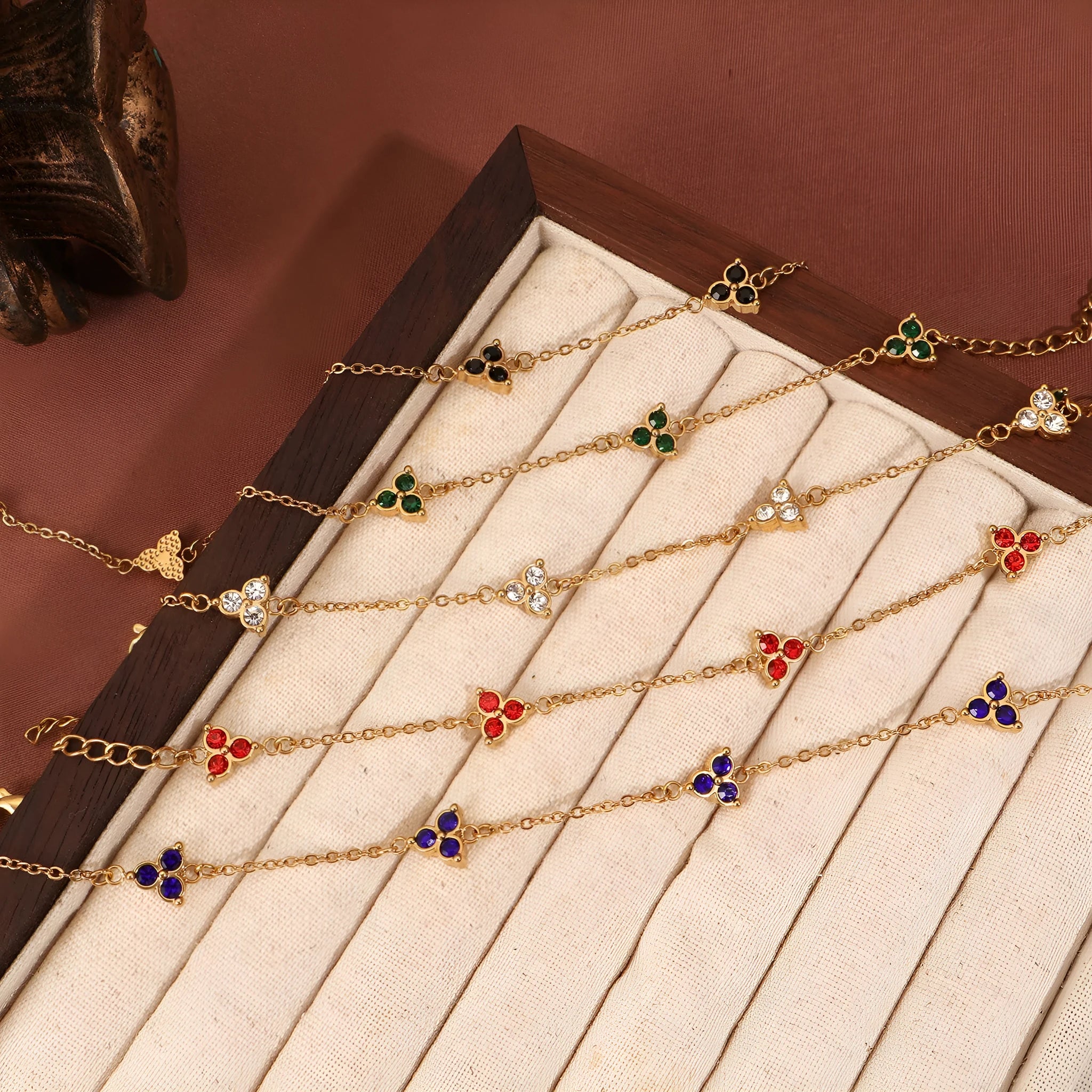 Women's stainless steel geometric triangle bracelet with a three-diamond pattern, shown in a gold and white zircon colour option.