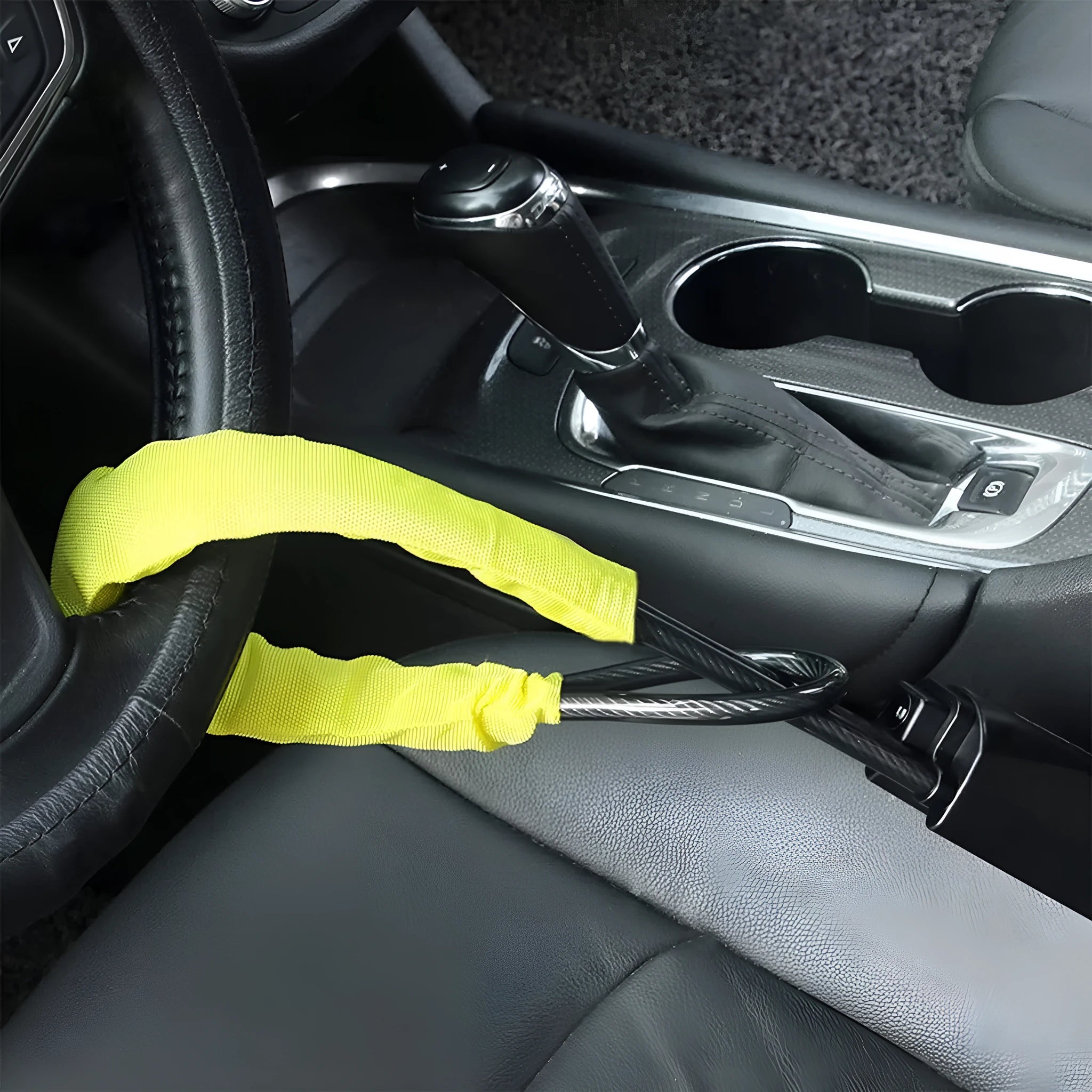 Red iron steering wheel lock with wire rope for a General Motors car.