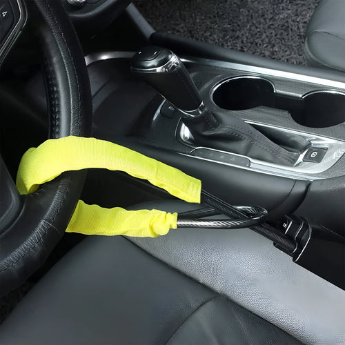 Red iron steering wheel lock with wire rope for a General Motors car.