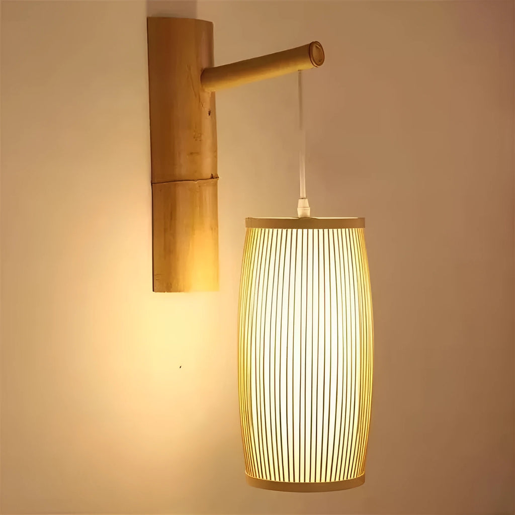 Natural bamboo plait cylindrical wall lamp with woven texture, shown mounted.
