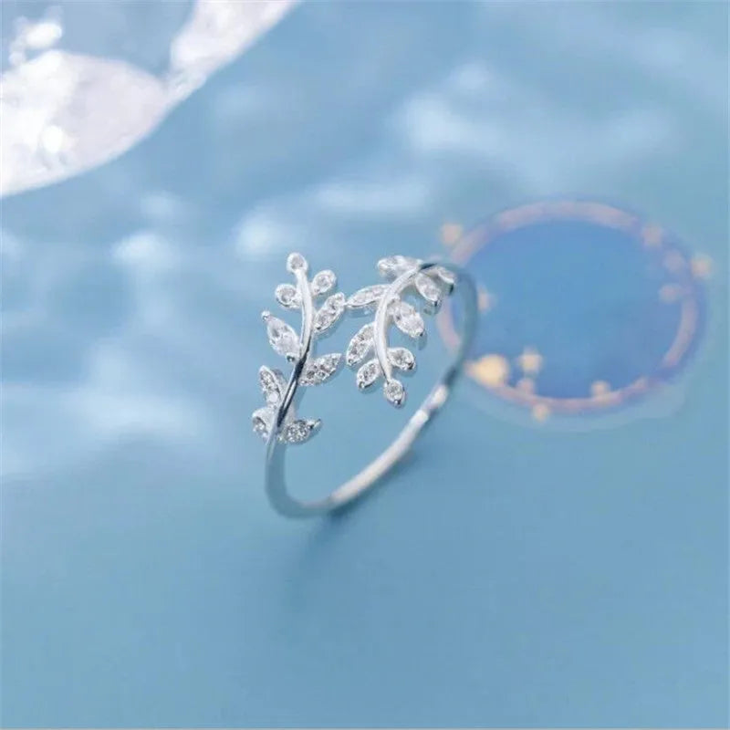 Gold and silver leaf-shaped branch ring for women on a white background.