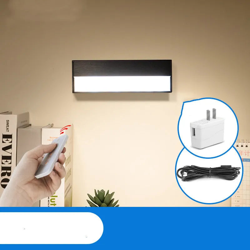 Compact white magnetic table lamp with a large luminous surface and USB charging port.
