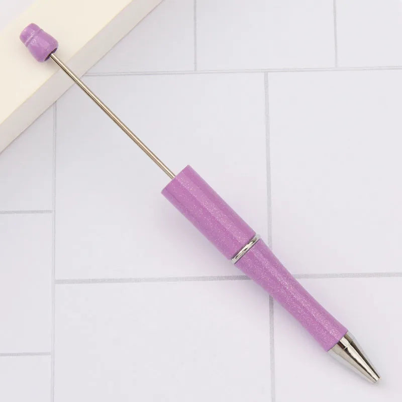 Creative ballpoint pen with multicoloured spinning plastic beads on a steel wire frame.