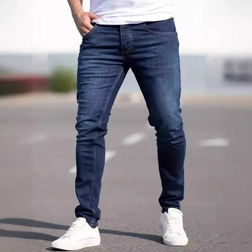 Men's dark blue slim fit casual jeans with skinny leg opening and mid waist