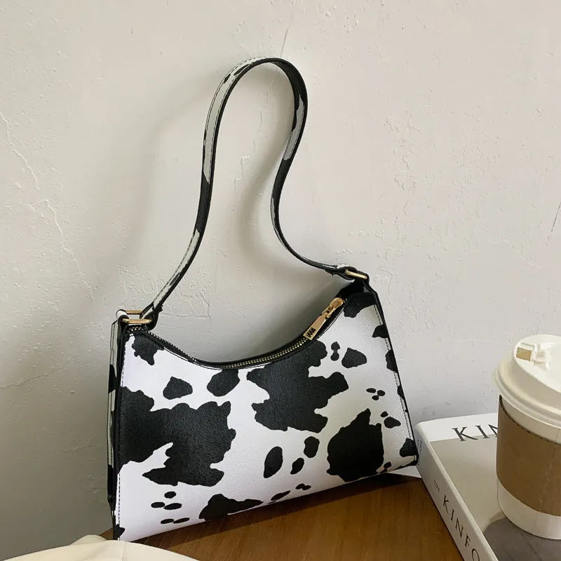 Korean-style small square underarm bag in PU material showing colour options including beige, black and animal prints