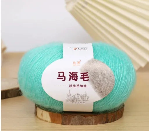 Single ball of mohair yarn in various colours for hand-woven DIY scarf knitting projects