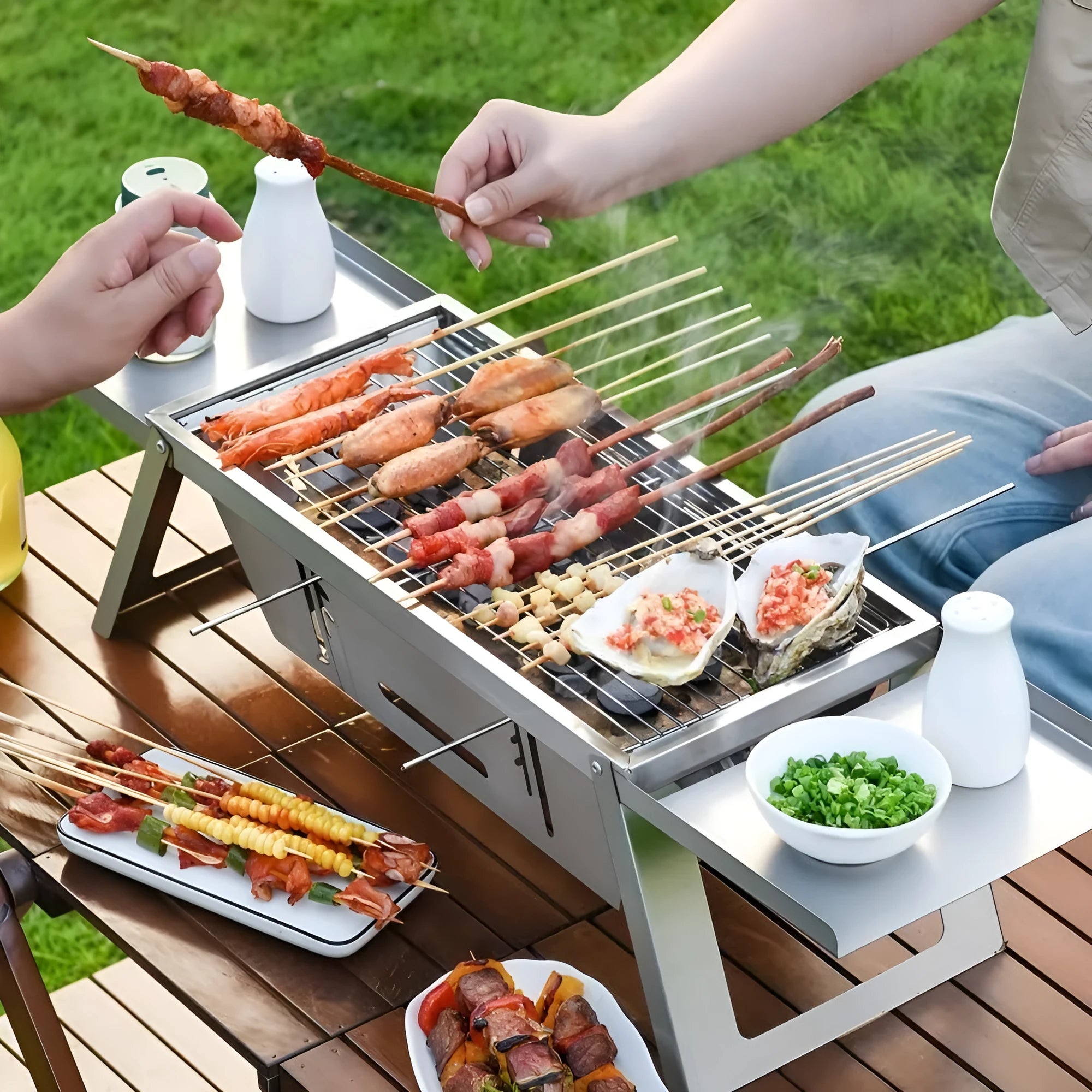 Small foldable portable charcoal grill for outdoor use