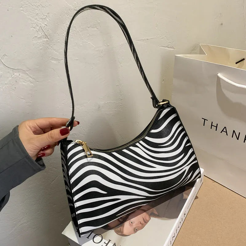Korean-style small square underarm bag in PU material showing colour options including beige, black and animal prints
