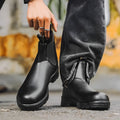 Vintage frosted brown Chelsea boot with round toe and mid-calf height on a neutral background.
