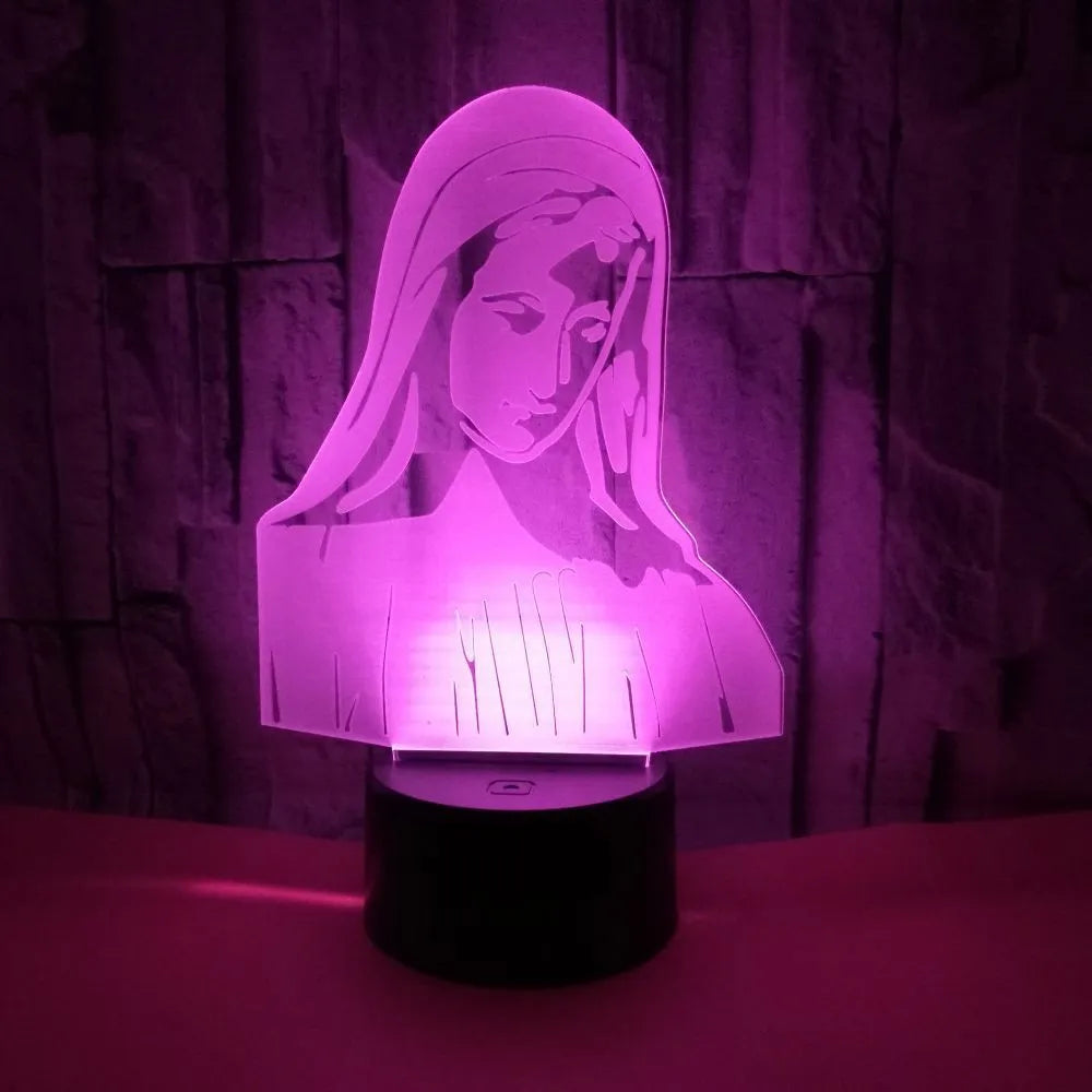 3D LED night light with colourful dual-ring pattern, remote control, and USB cable on a desk.