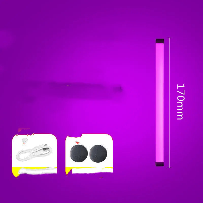 Blue and purple rechargeable LED tube light with USB cable on a dark background.