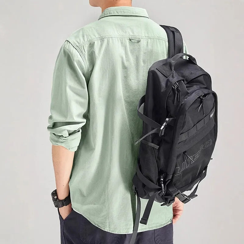 Man wearing a loose fit, long sleeve cardigan-style shirt overall in khaki polyester fabric.