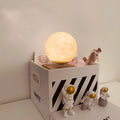 Floating magnetic levitation moon planet lamp with LED light and astronaut figures on desk