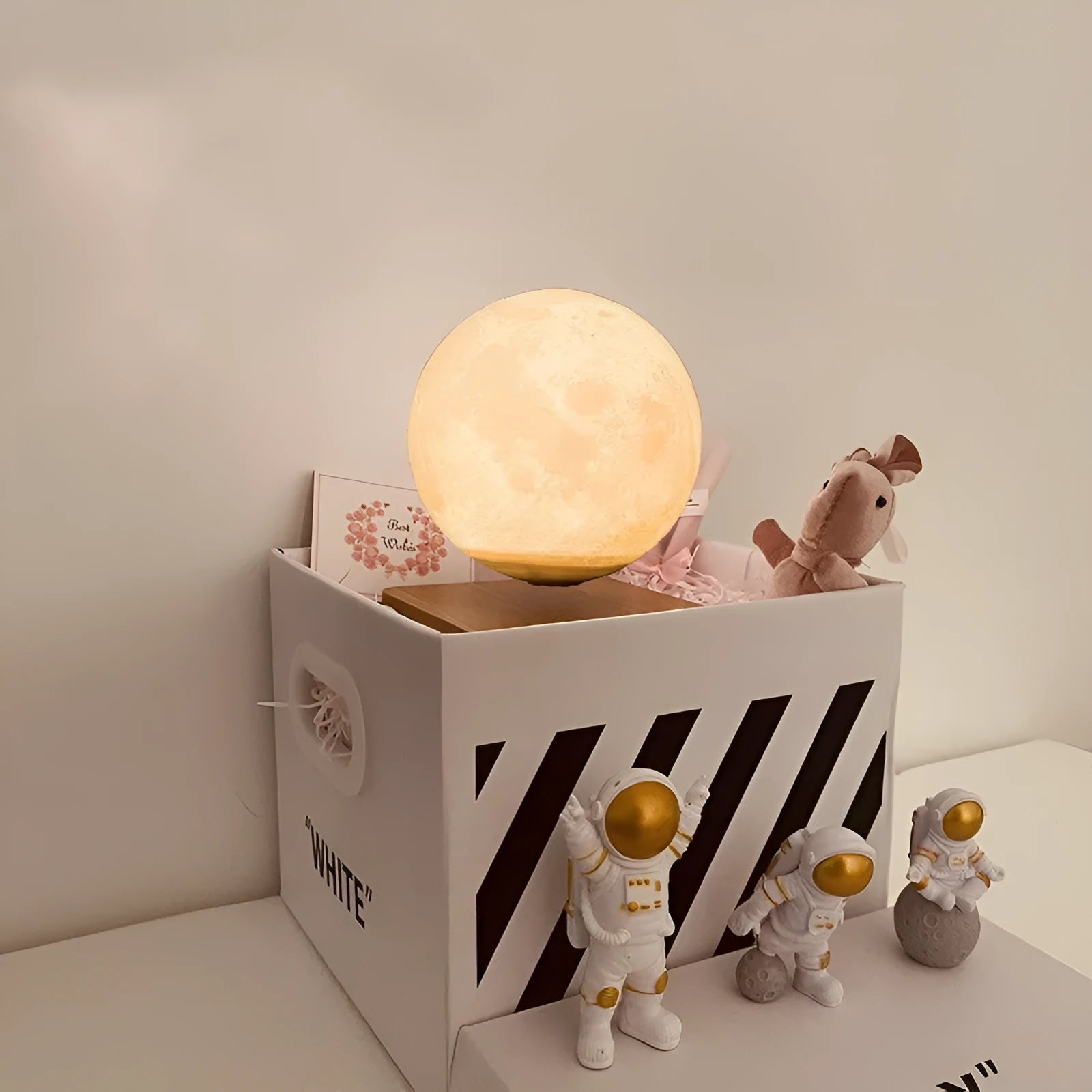Floating magnetic levitation moon planet lamp with LED light and astronaut figures on desk
