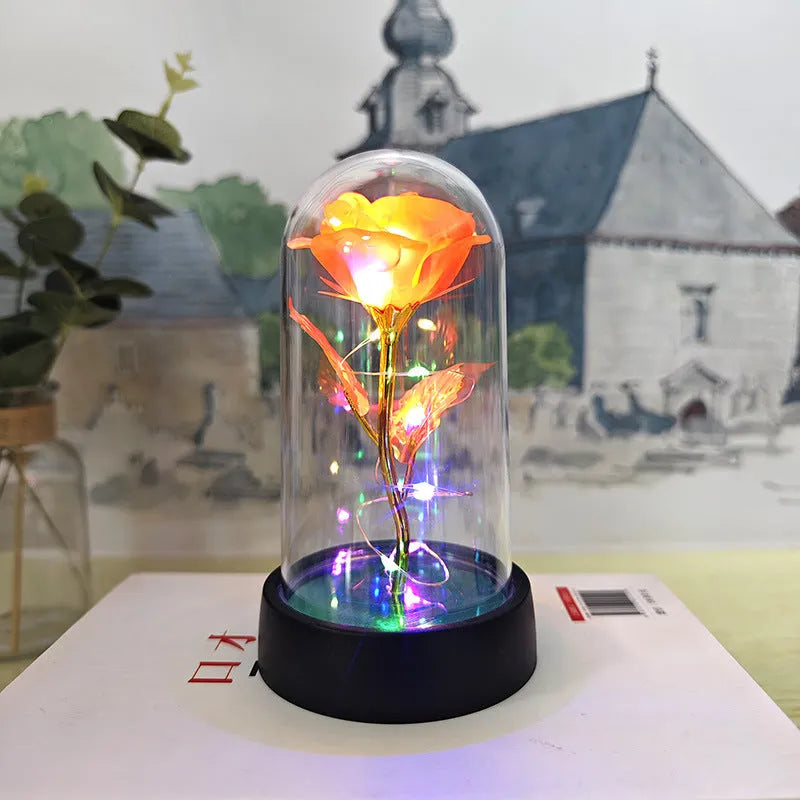 Small plastic night lamp with floral decoration and coloured light options on a black base.