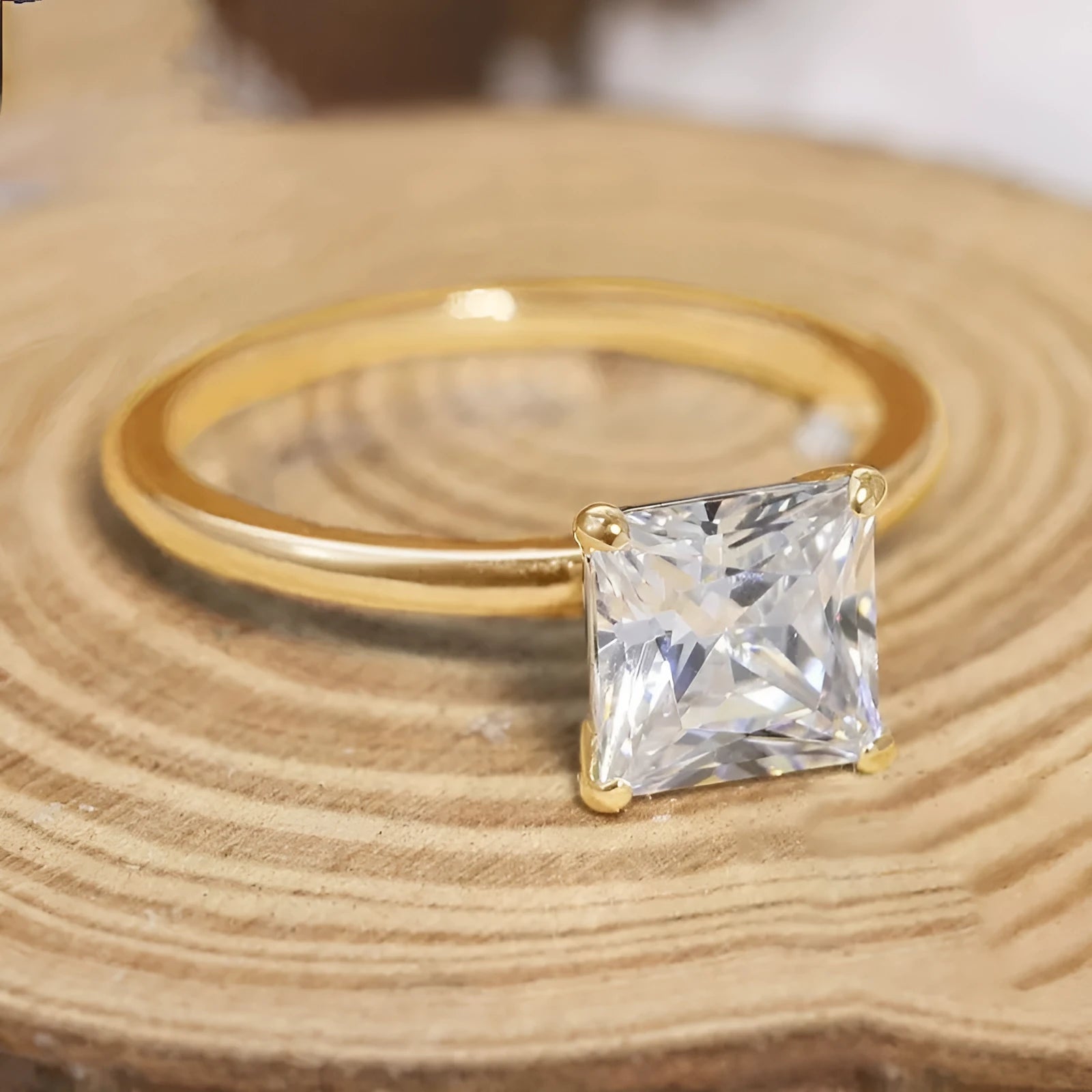 Simple geometric 925 silver ring for women in gold, rose gold, or silver colour on a grey background.