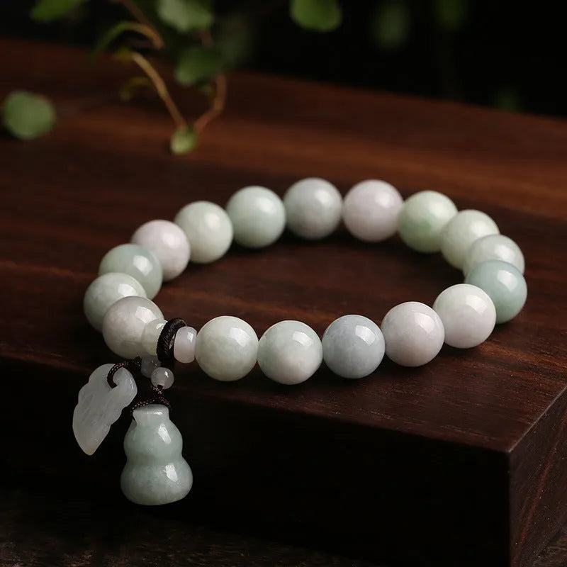 Natural emerald jade geometric bracelet with Maitreya Buddha, apple, and money bag hanging charms.