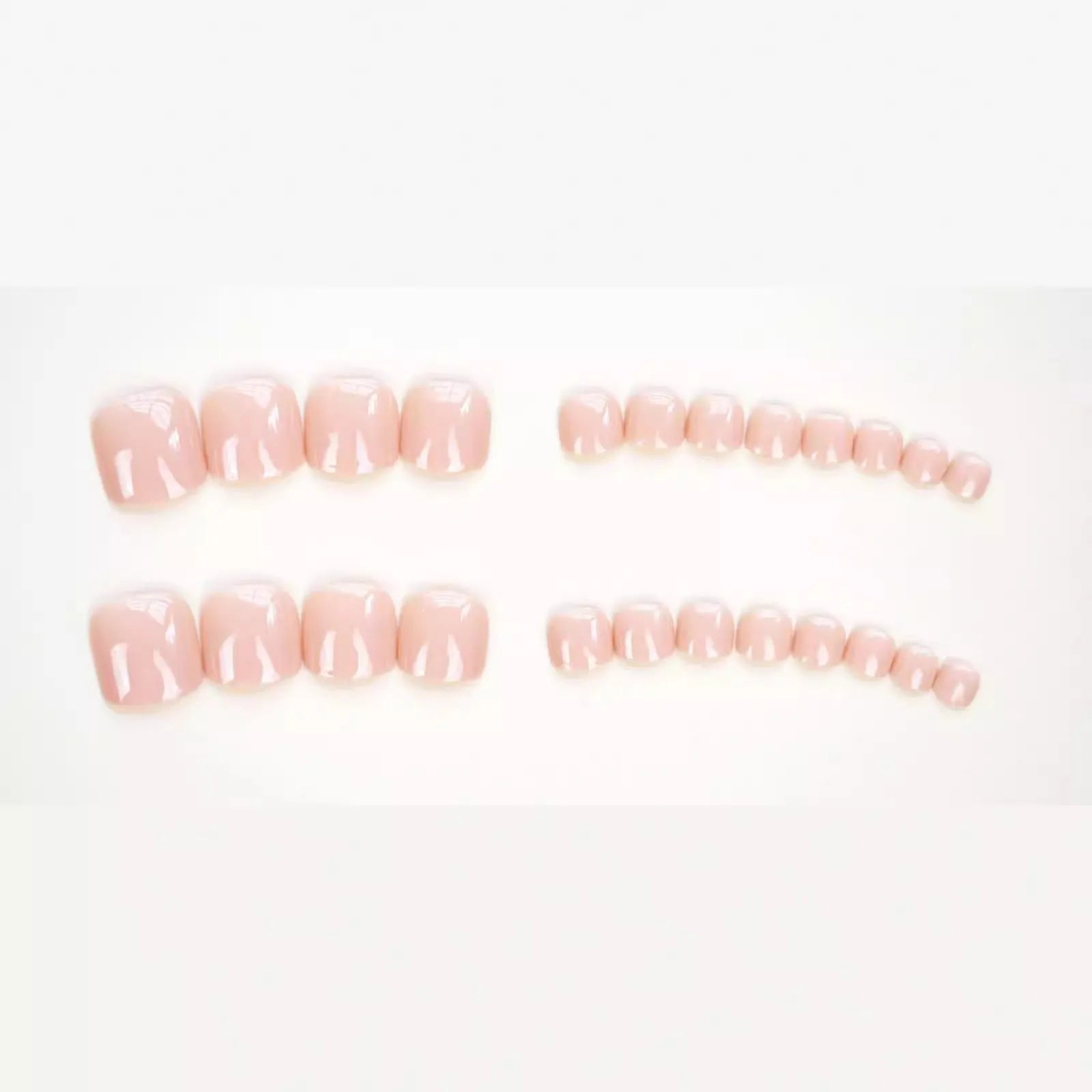 Plastic toenail stickers in skin colour J-52 with a tube of glue for application.