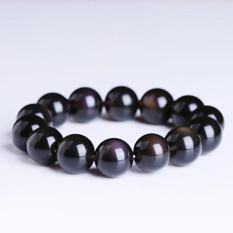 A polished crystal Pi Xiu bracelet with geometric beads on a white background.