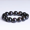 A polished crystal Pi Xiu bracelet with geometric beads on a white background.