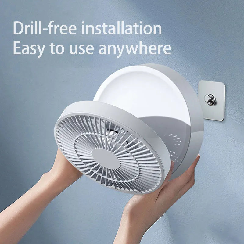 White portable folding desk fan with remote control and warm night light on a table