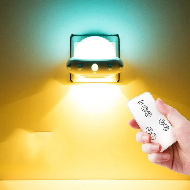 Remote control UFO shaped bedside night light in blue, pink, or white colour.