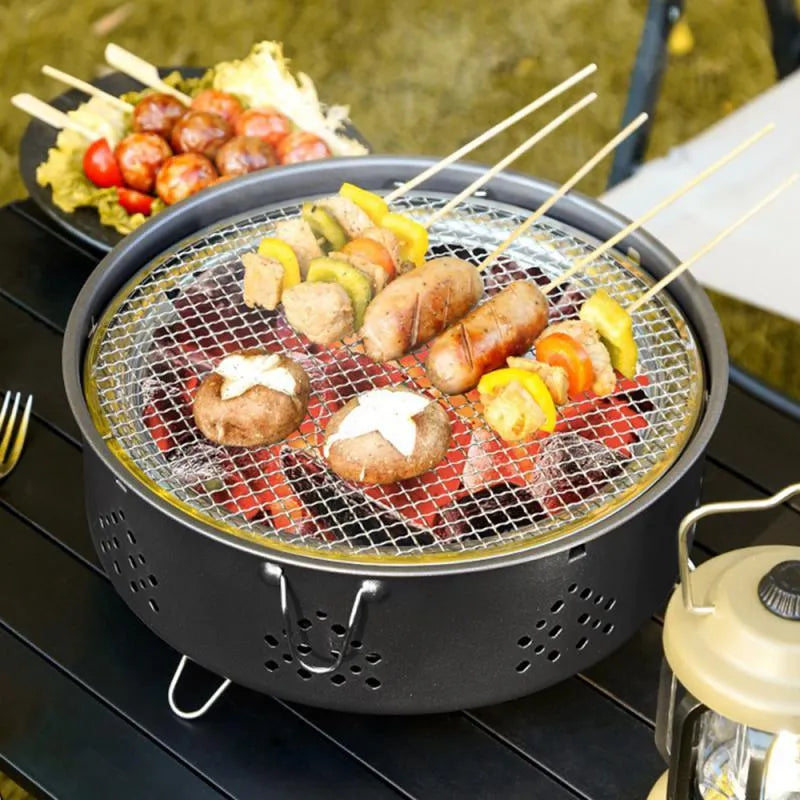 Portable stainless steel charcoal barbecue grill with detachable parts and a carry bag.