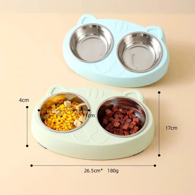 Blue plastic double bowl pet feeding tray for cats and dogs with non-slip rubber feet on a floor.