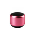 A compact portable Bluetooth mini speaker in black, blue, gold, or pink colour.
