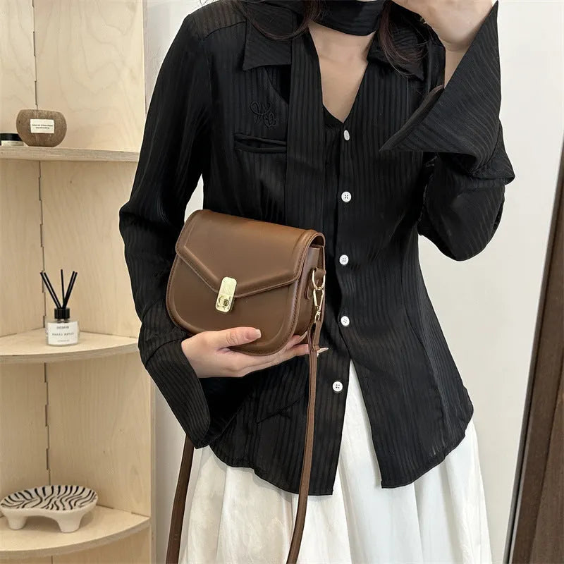 Soft PU shoulder messenger bag in horizontal square clamshell shape with niche texture.