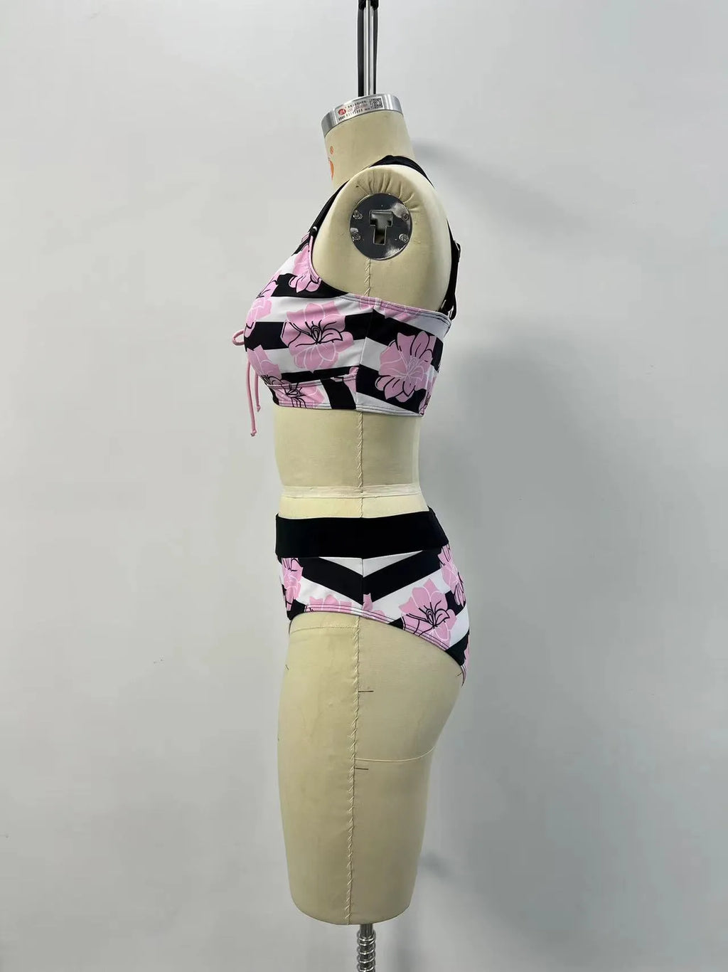 Black women's printed split bikini with high-waisted brief for belly coverage.