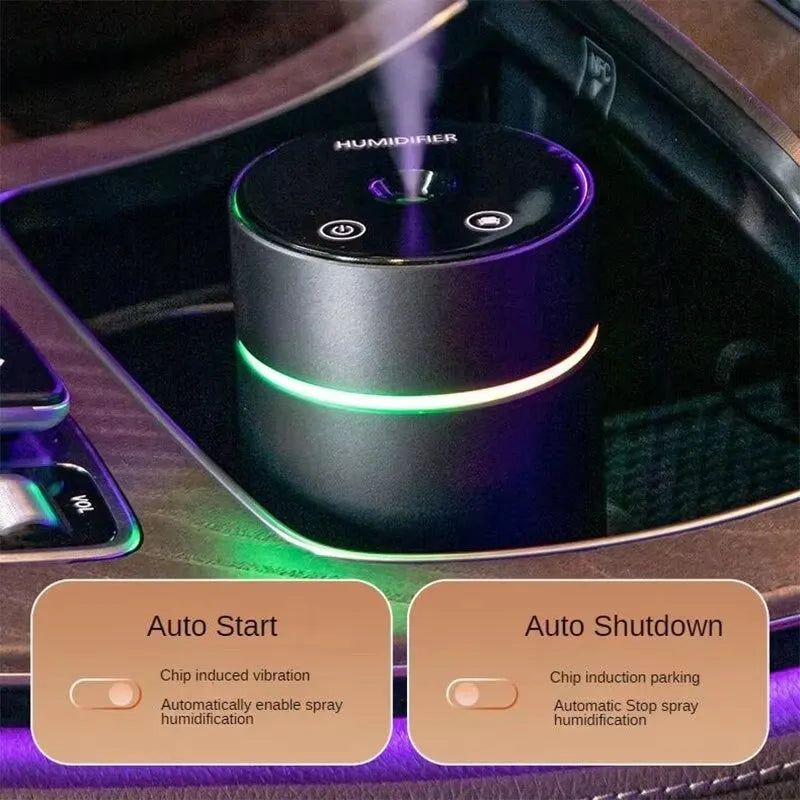 Black aluminium car humidifier and essential oil diffuser with colourful night light on, 66mm wide.