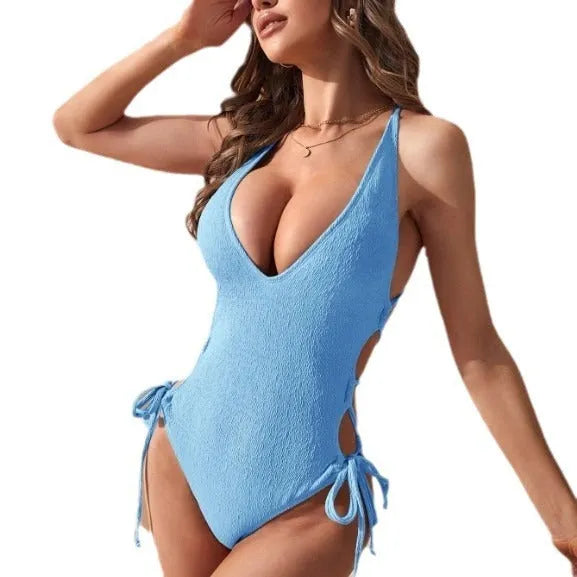 Women's solid colour hollow backless one-piece swimsuit on a mannequin, shown in light blue.