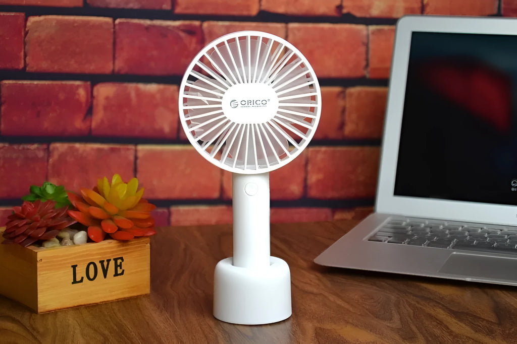 White ORICO FH1 portable USB desk fan with rechargeable battery on a desk