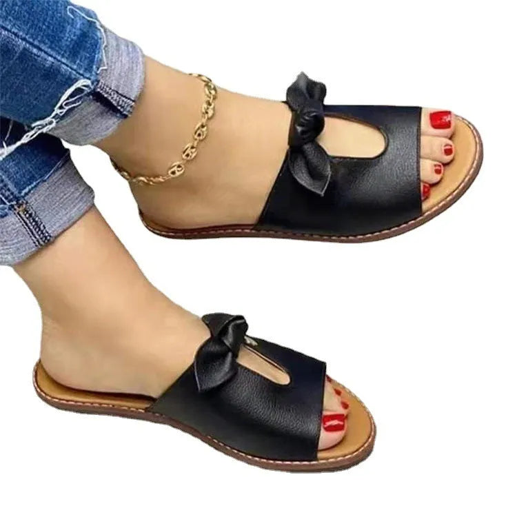 Ladies casual sandals with bow decoration and fish mouth toe opening in black, pink, and gold colours.