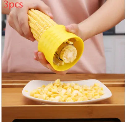 Yellow corn-shaped manual kitchen thresher for peeling corn kernels.