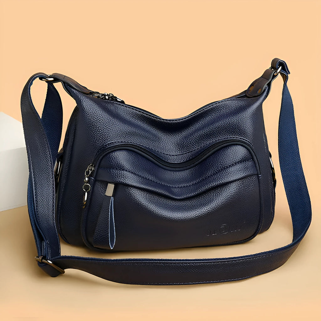 Blue horizontal square women's shoulder bag with soft PU construction and visible sewing thread detailing