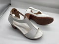 Plus size women's beige open toe wedge sandals with a buckle strap and low heel on a white background.