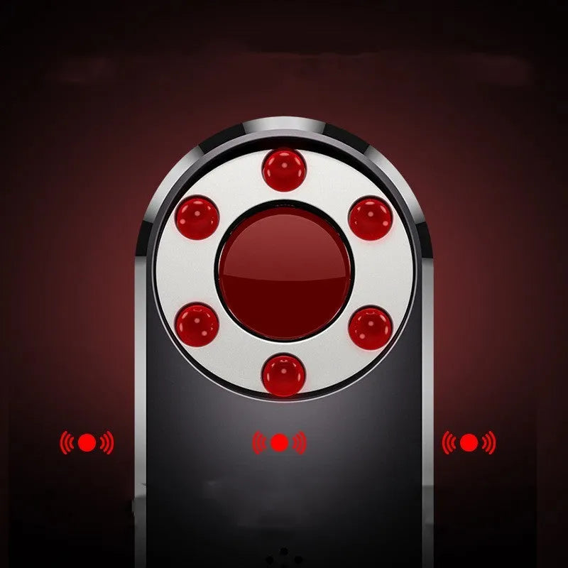 AK400 portable infrared anti-monitoring detector with USB cable on a table.