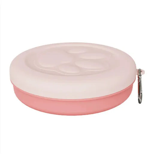 Collapsible silicone dog bowl in light pink and green colours showing portable feeding design
