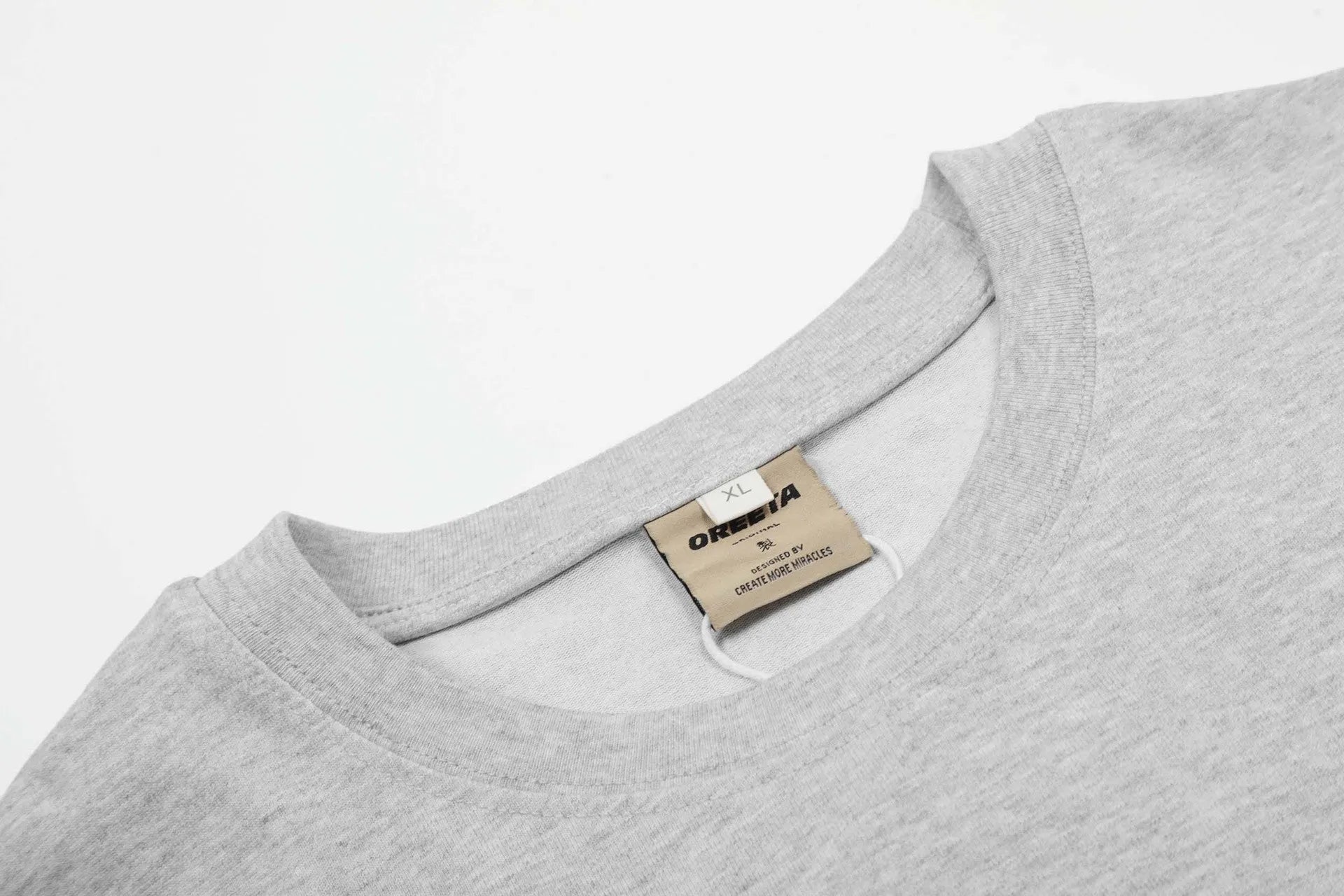 Man wearing a loose fit grey long sleeve cotton t-shirt for casual wear.
